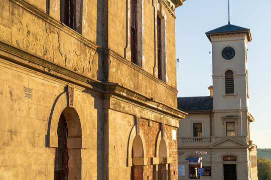 Streetscape with historic buildings and clock tower in golden light