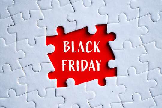 Black Friday text on red missing puzzle piece in white jigsaw background, shopping sale and retail concept