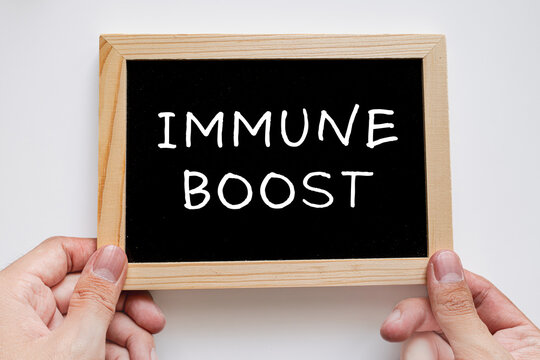 Immune Boost text on black chalkboard, health and immunity medical concept
