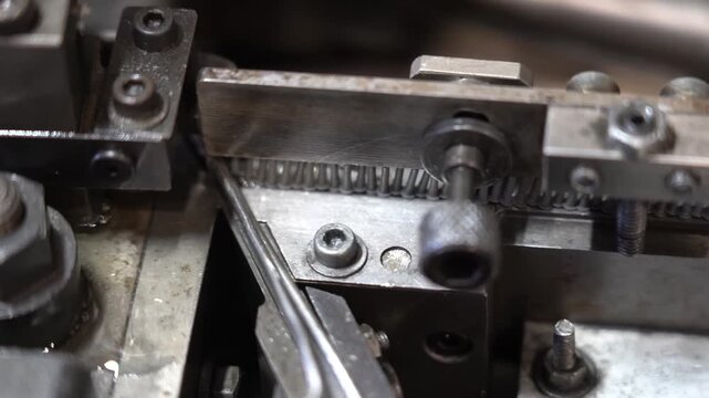 Steel chute and clamping jaws feed blanks through a threading unit inside a fastener production machine