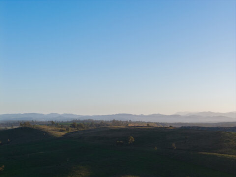 Layered mountains in the hazy distance with open cut coal mine in foreground