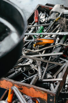 Assorted mechanic tools are ready for use in a full metal toolbox, useful for repair work