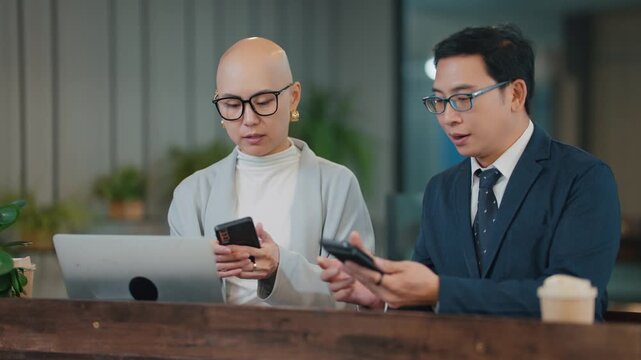 Two coworkers meeting for the first time exchange contact information by scanning QR codes on their smartphones. Workplace networking