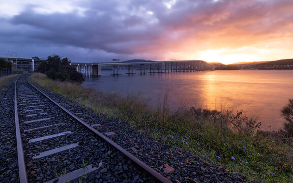 Tasman Bridge at sunrise, with Southern Line railway in foreground