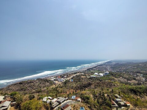 Scenic panoramic landscape of Java Southern Coast and crashing Parangtritis Beach waves captured from Obelix Sea View cliff top.