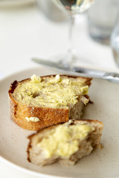 buttered sourdough bread pieces on side plate