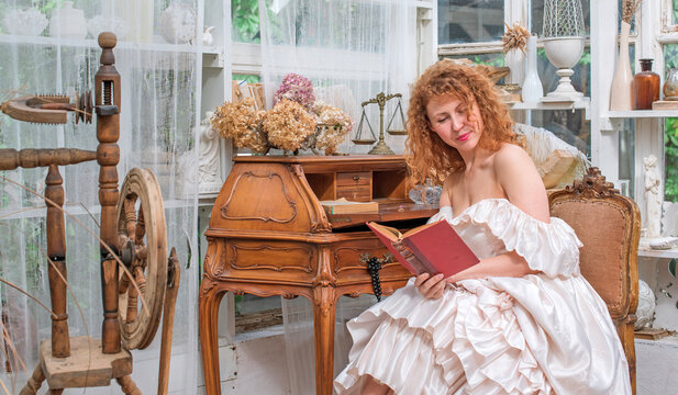 Romantic Victorian Woman Reading an Old Book. Perfect for concepts of reading, women&rsquo;s fiction, classic literature, imagination and book lovers