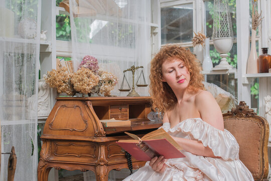 Romantic Victorian Woman Reading an Old Book. Perfect for concepts of reading, women&rsquo;s fiction, classic literature, imagination and book lovers