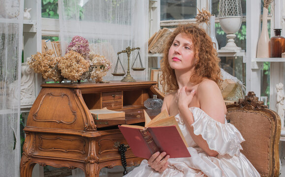 Romantic Victorian Woman Reading an Old Book. Perfect for concepts of reading, women&rsquo;s fiction, classic literature, imagination and book lovers