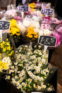 Bright bunches of fresh flowers are displayed at a market stall