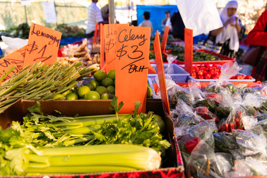 Vibrant farmers market scene filled with fresh produce and handwritten price signs