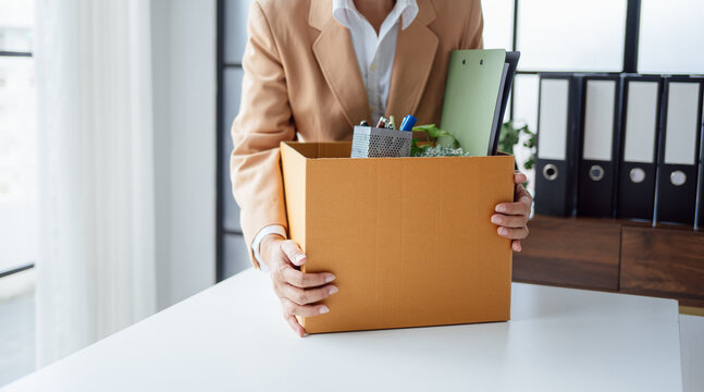 Quit Job senior asian business woman sending resignation letter and packing Stuff Resign Depress or carrying business cardboard box in office layoff retired from company.