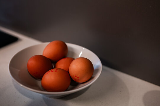 Five eggs are placed in a bowl on a kitchen counter for cooking breakfast in Crackenback