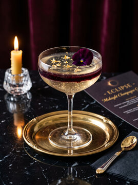 Luxury pale golden champagne jelly and delicate blackberry layers, midnight Halloween mood with candle