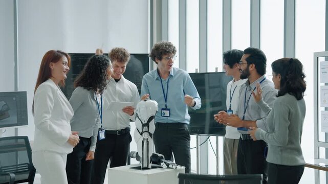 Diverse engineering team celebrating a successful robotics project with a humanoid robot in a modern technology laboratory, representing teamwork, innovation, artificial intelligence, research, and te