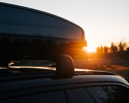 Close up of a car with a roof box at sunset