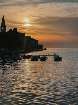 Sunset Over Coastal Town with Reflections