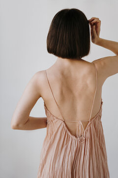 Woman Wearing Backless Dress in Studio Shot