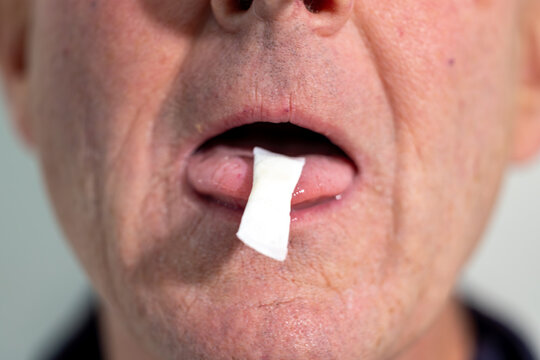 Stockholm, Sweden A man places a smokeless and tobacco-free nicotine pouch or snus on his tongue.