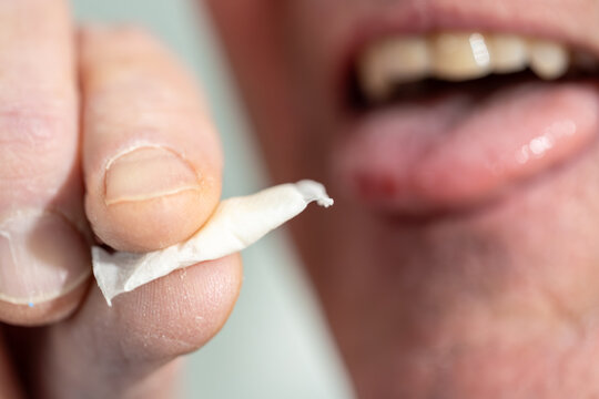 Stockholm, Sweden A man places a smokeless and tobacco-free nicotine pouch or snus on his tongue.