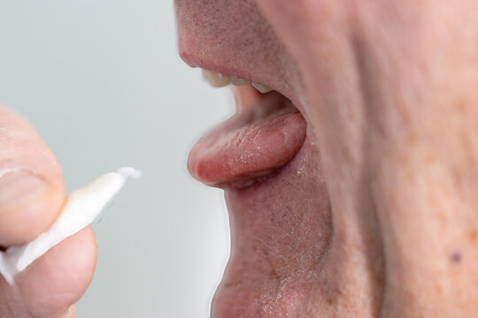 Stockholm, Sweden A man places a smokeless and tobacco-free nicotine pouch or snus on his tongue.
