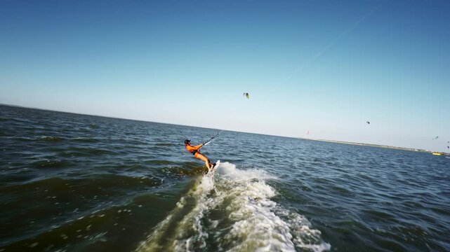 Person kitesurfing across open water on a board