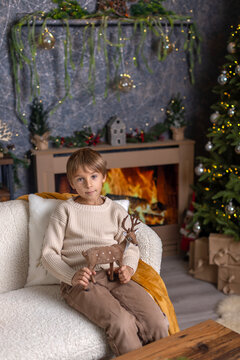 Happy child on Christmas, enjoying some quality time, opening presents, kids on Christmas eve in decorated home
