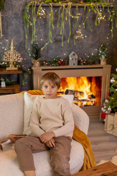 Happy child on Christmas, enjoying some quality time, opening presents, kids on Christmas eve in decorated home