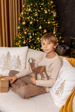 Happy child on Christmas, enjoying some quality time, opening presents, kids on Christmas eve in decorated home