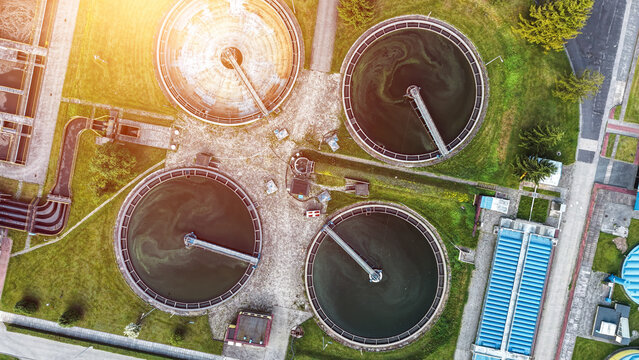 Modern water treatment facility with circular clarifier tanks from drone