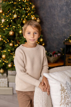 Happy child on Christmas, enjoying some quality time, opening presents, kids on Christmas eve in decorated home