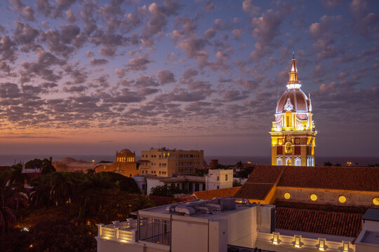 Colonial cathedral with domed towers in Cartagena framed against the modern Bocagrande skyline near the Caribbean Sea