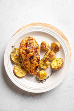 Oven roasted lemon garlic chicken and potatoes on plate