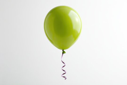 A single lime green balloon with a purple ribbon isolated on white background