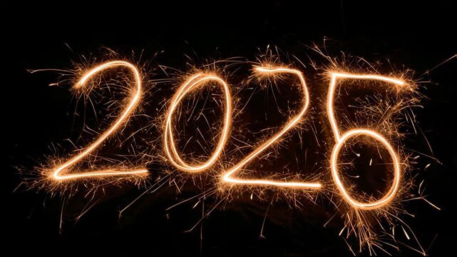 Numbers representing different years light up with sparklers against a dark backdrop, showcasing a festive atmosphere and celebrations.