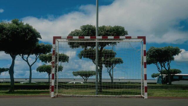 Empty street soccer goal with net on an outdoor futsal court under blue sky with clouds, S&atilde;o Miguel, Azores, Portugal