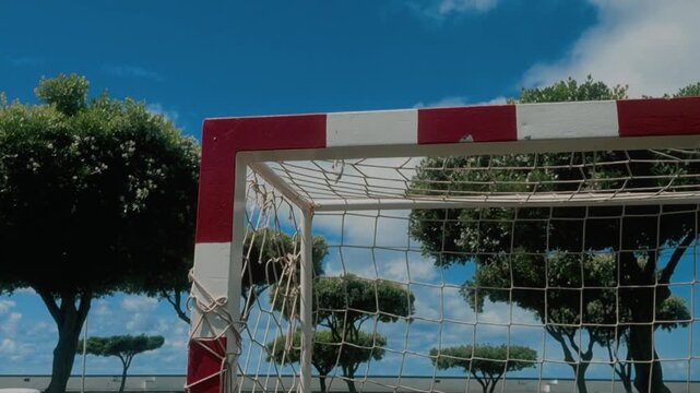 Empty street soccer goal with net on an outdoor futsal court under blue sky with clouds, S&atilde;o Miguel, Azores, Portugal