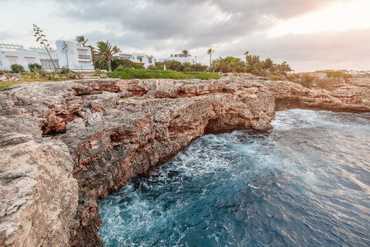Rugged sea arch on rocky coast in Cala d'Or, Mallorca, Spain.