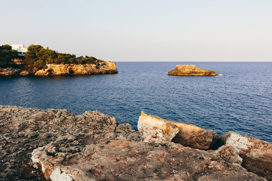 Sea cliffs with small islet in Cala d'Or, Mallorca, Spain.