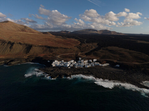 Aerial view shows Tenesar hamlet on volcanic coast in Lanzarote