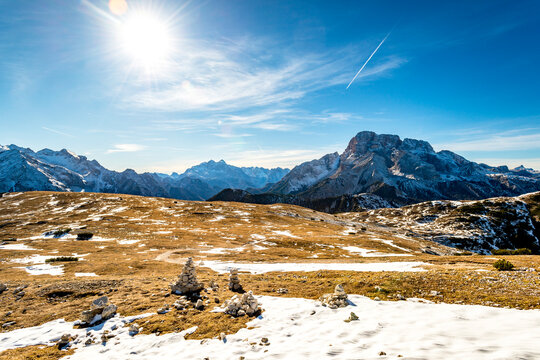 Stone cairns decorate the snowy mountain landscape in South Tyrol