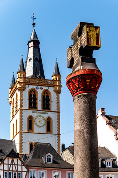 The market cross stands before St Gangolf church in Trier Germany