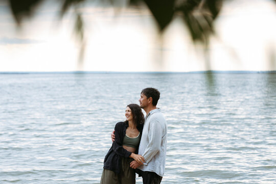 A smiling couple enjoys their summer weekend by the sea