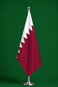 3D illustration. Flag of Qatar on a ceremonial standing flag on a pole with a metal base.
