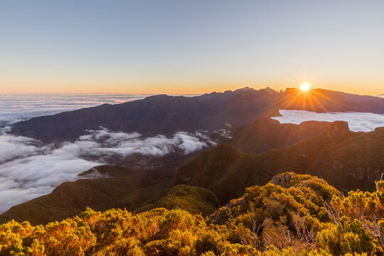 Sunrise over foggy mountains at Bica da Cana viewpoint in Madeira