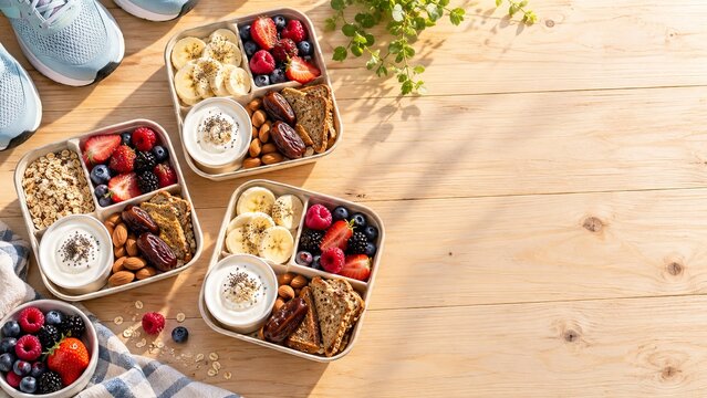 Pre workout snack boxes prepared for active mornings on a light wood table