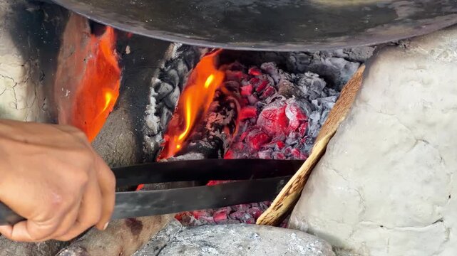 Making roti ya baking bread chapati on the mud stove or clay stove traditional food 4k footage
