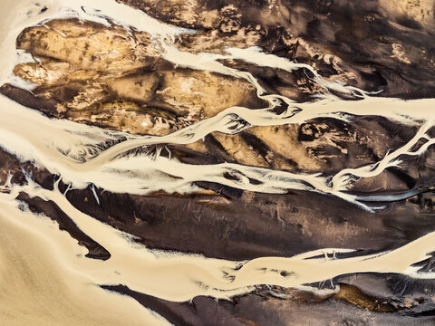 Glacial meltwater flows through volcanic sand in Iceland