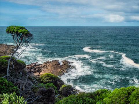 Swirling Patterns Of Wash From Surf Pounding Rocks