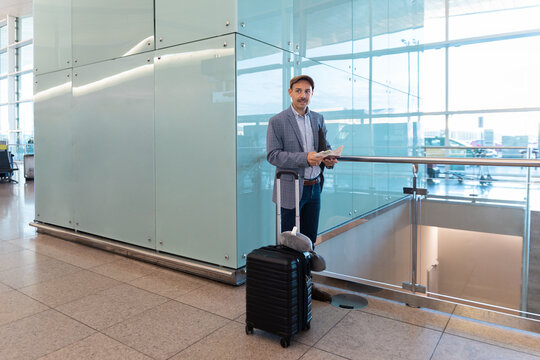 A man holds a ticket at the Barcelona airport terminal